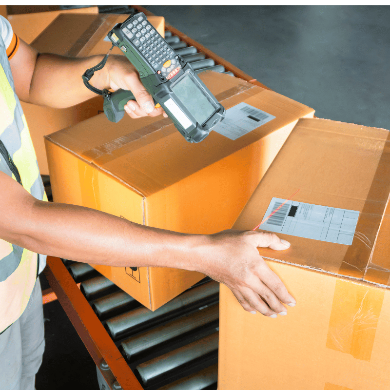 worker scanning package for shipment