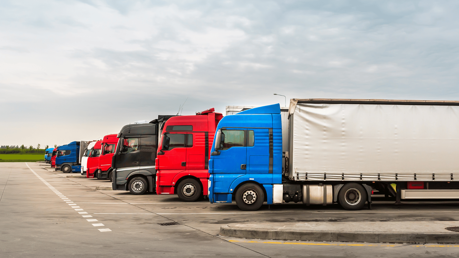 trucks with cargo containers in a parking lot