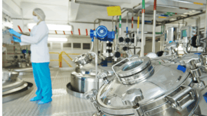 Employee in mixing area at pharmaceutical chemical manufacturing plant