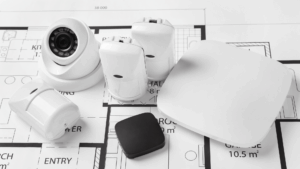 Flatlay of ONVIF-compatible IP cameras for commercial buildings and other equipment on top of a floor plan