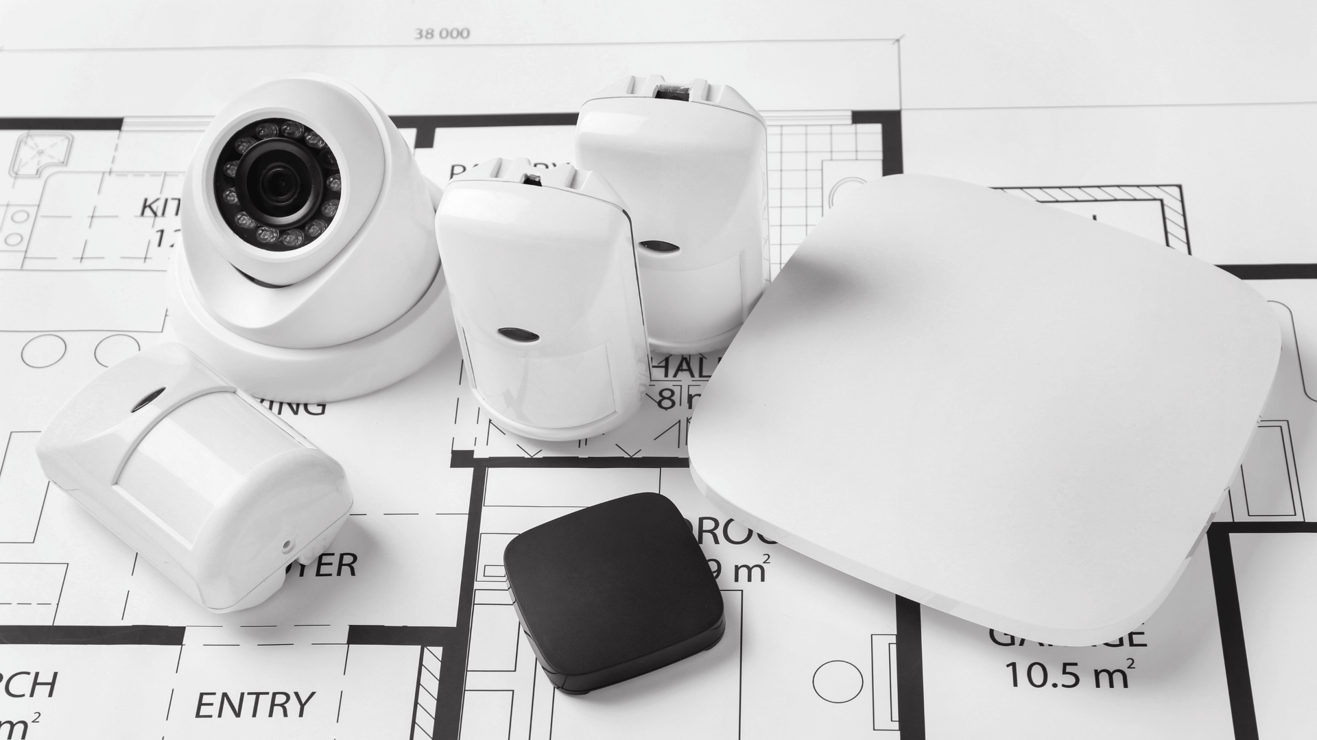 Flatlay of ONVIF-compatible IP cameras for commercial buildings and other equipment on top of a floor plan