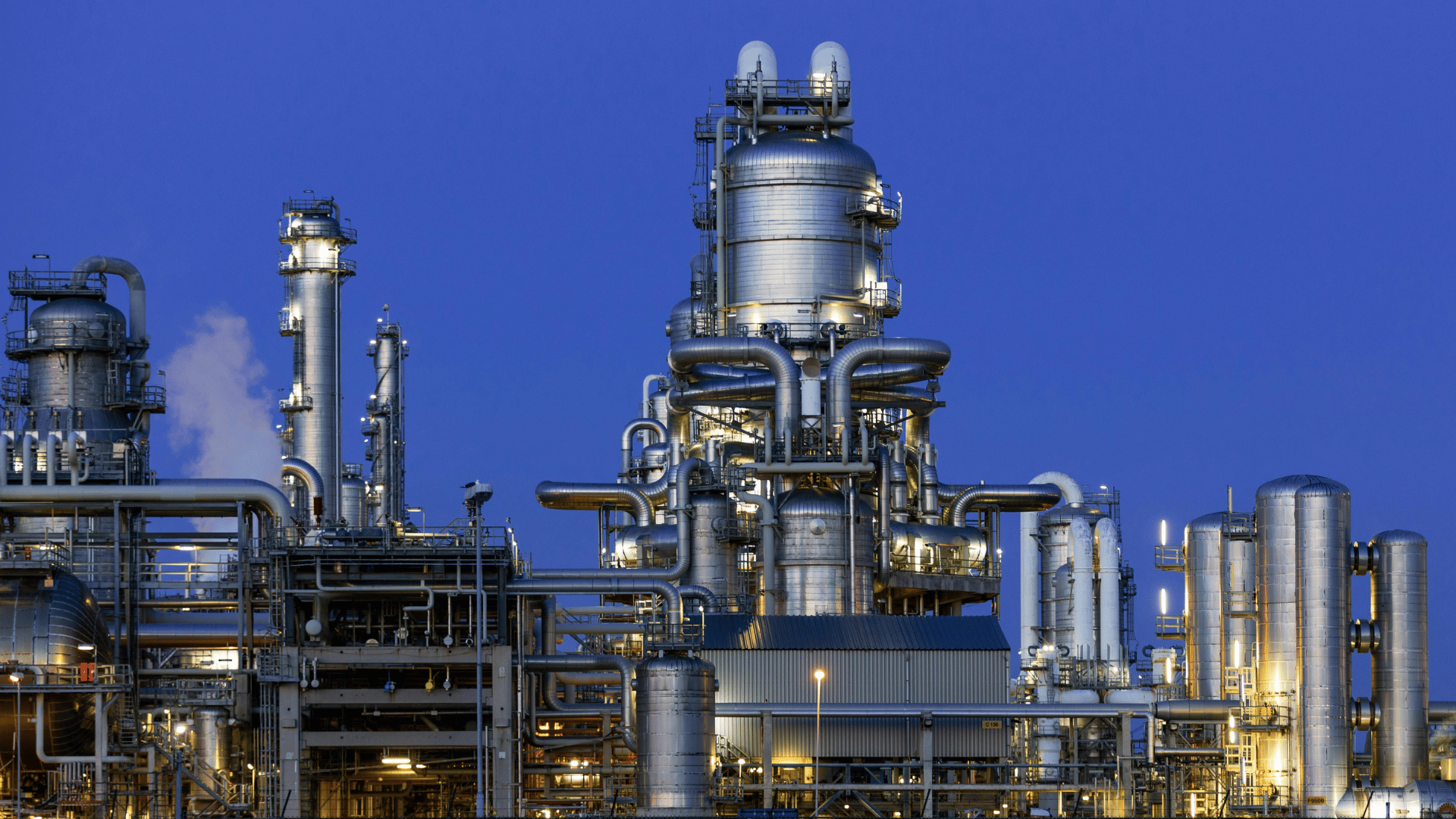 Landscape view of an industrial oil refinery at nighttime