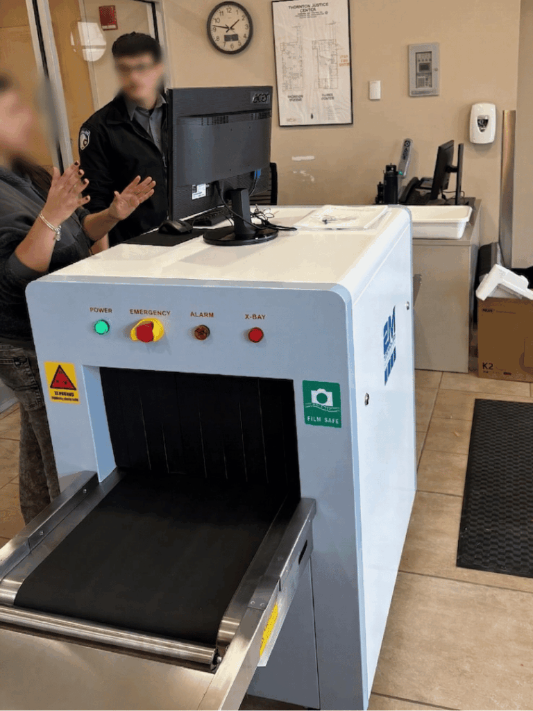 2M Technology technician training security staff on X-ray scanner at Thornton Municipal Court in Charles J. Rose Courthouse