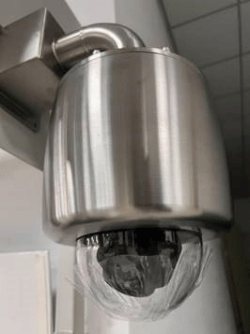 Closeup of mounted Verkada CD52 dome camera with custom explosion-proof housing