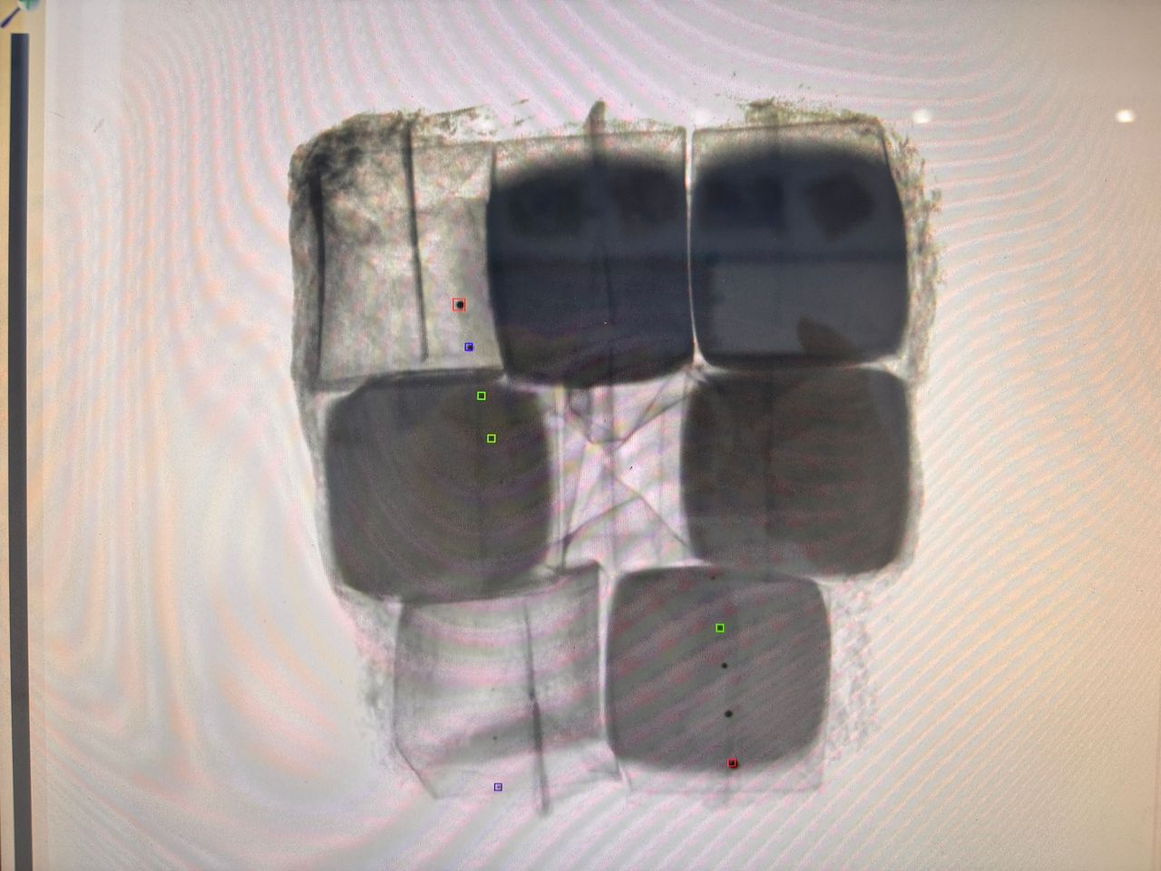 X-ray contaminant detection markers on juice cup tray showing detected foreign body positions