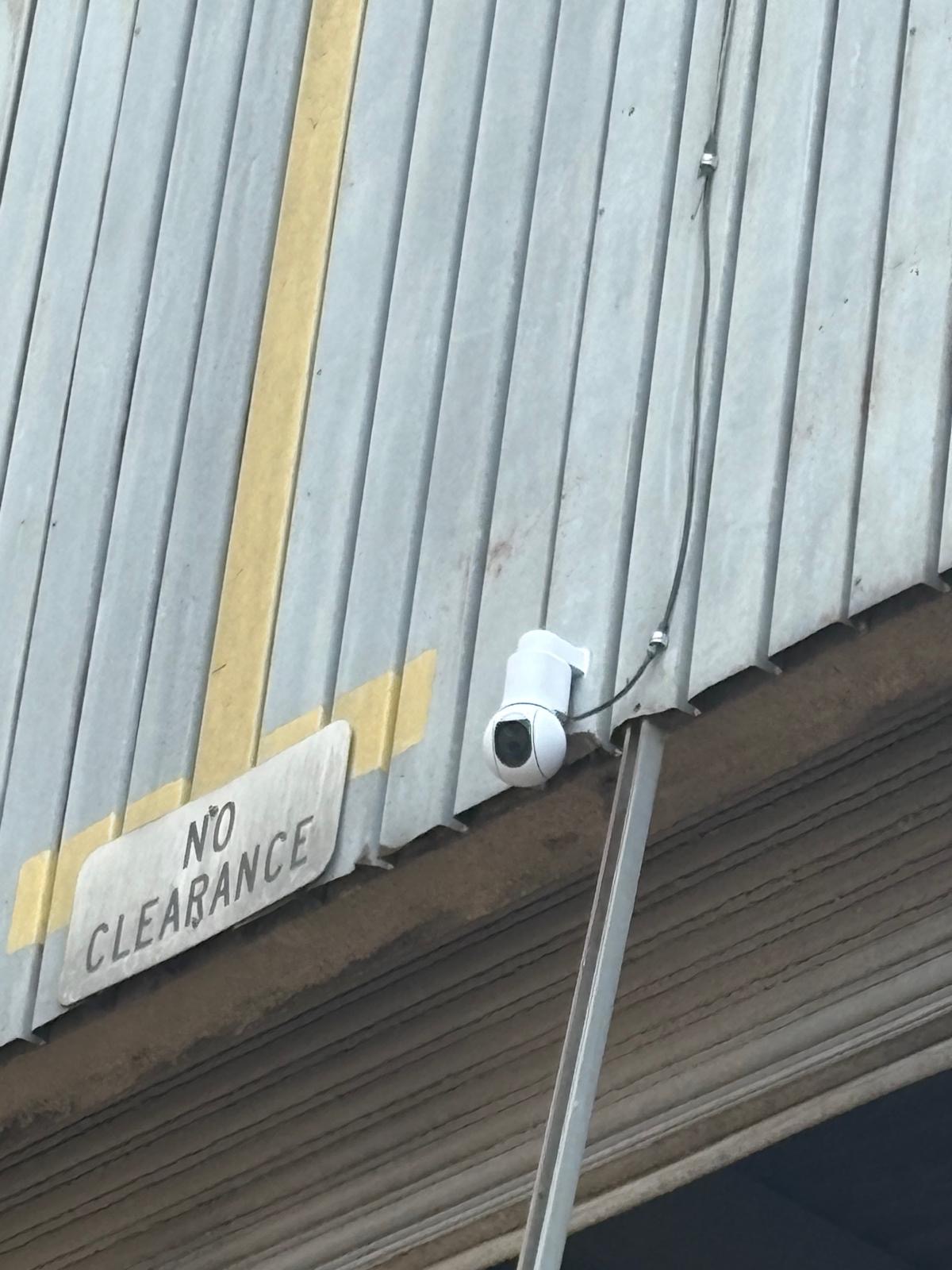 Closeup of Ubiquiti UniFi G6 PTZ camera overlooking bay door of grain silo