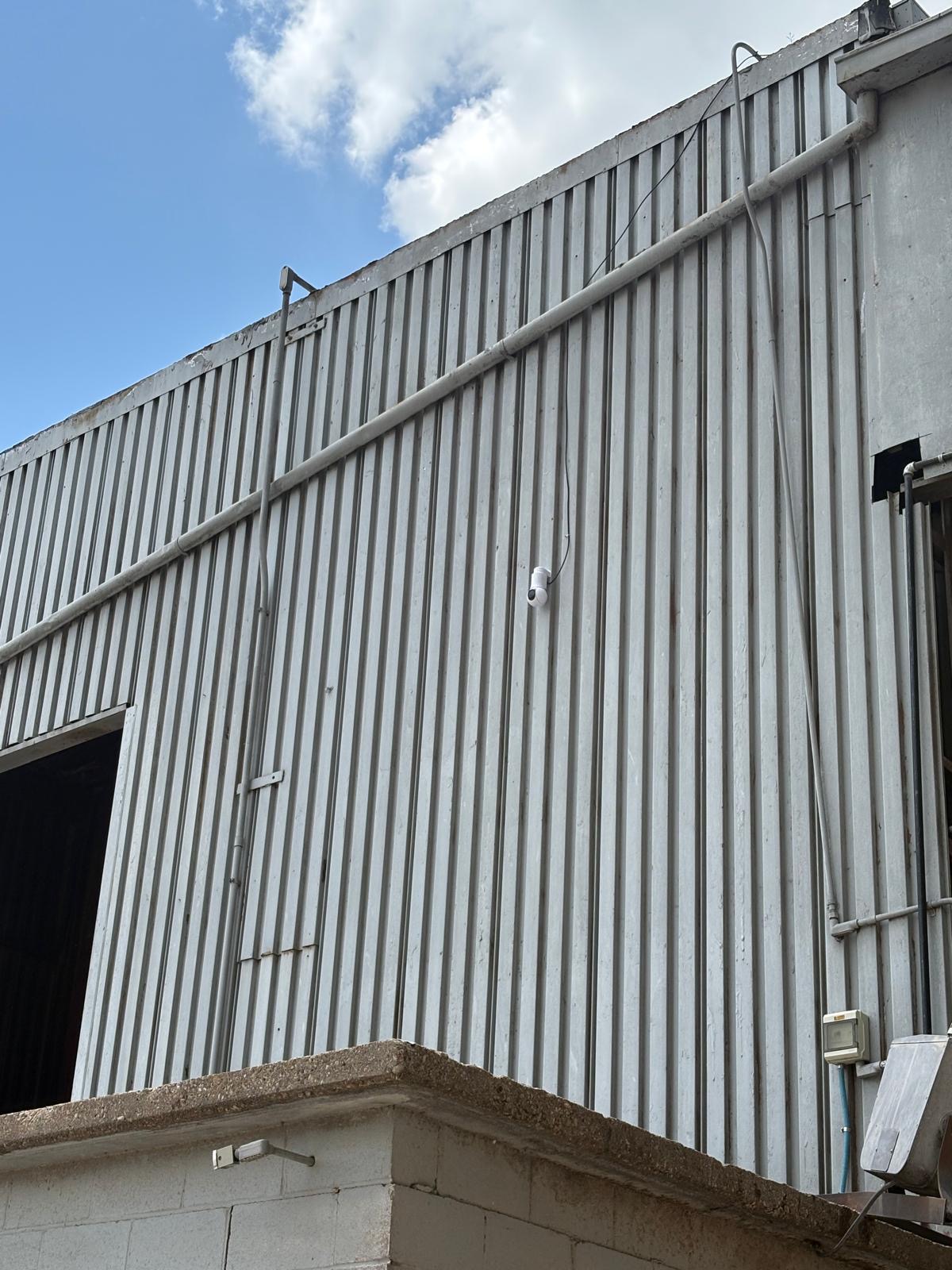 Ubiquiti UniFi G6 PTZ camera mounted on side wall of grain silo