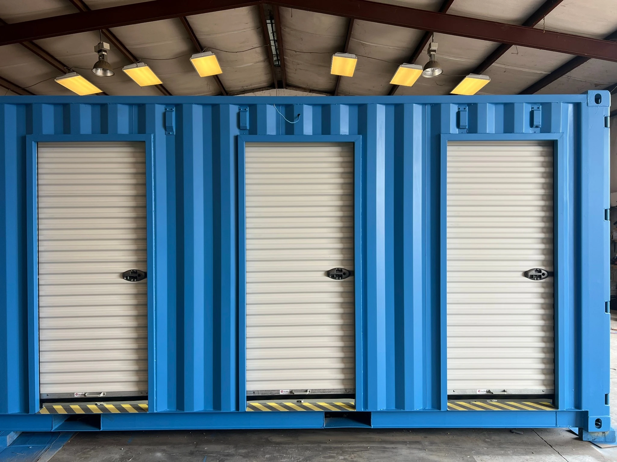 Portable container security checkpoint with roll-up security doors closed — completed unit ready for delivery Texas