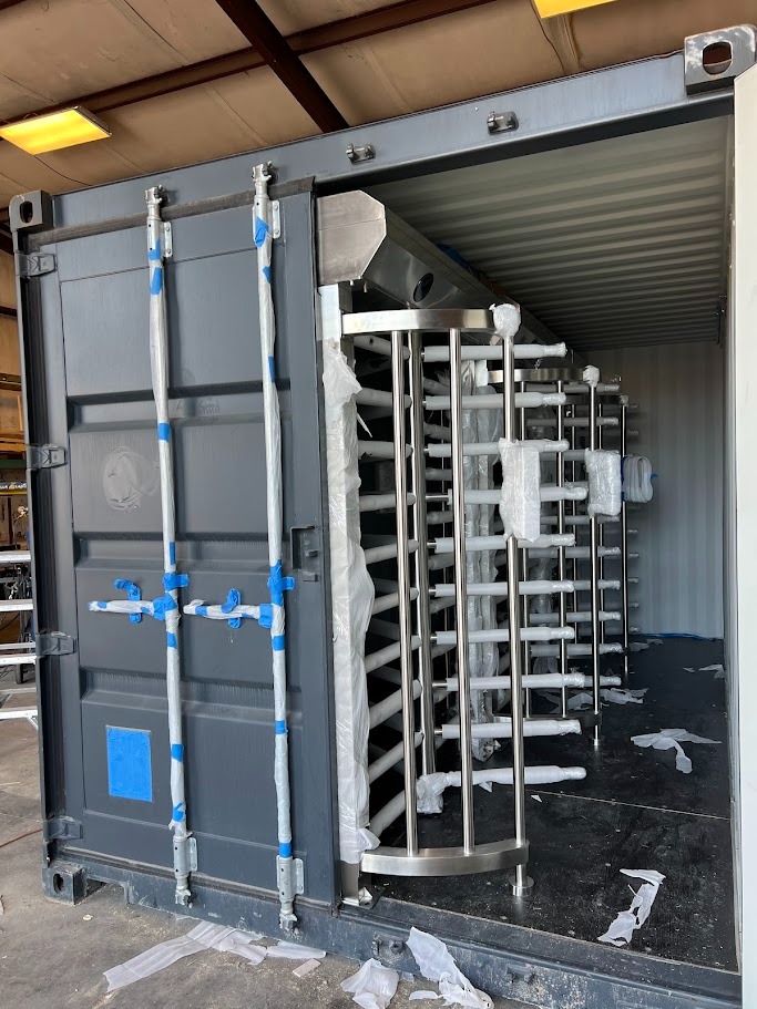 Container security checkpoint under fabrication — turnstile mechanism positioning inside container