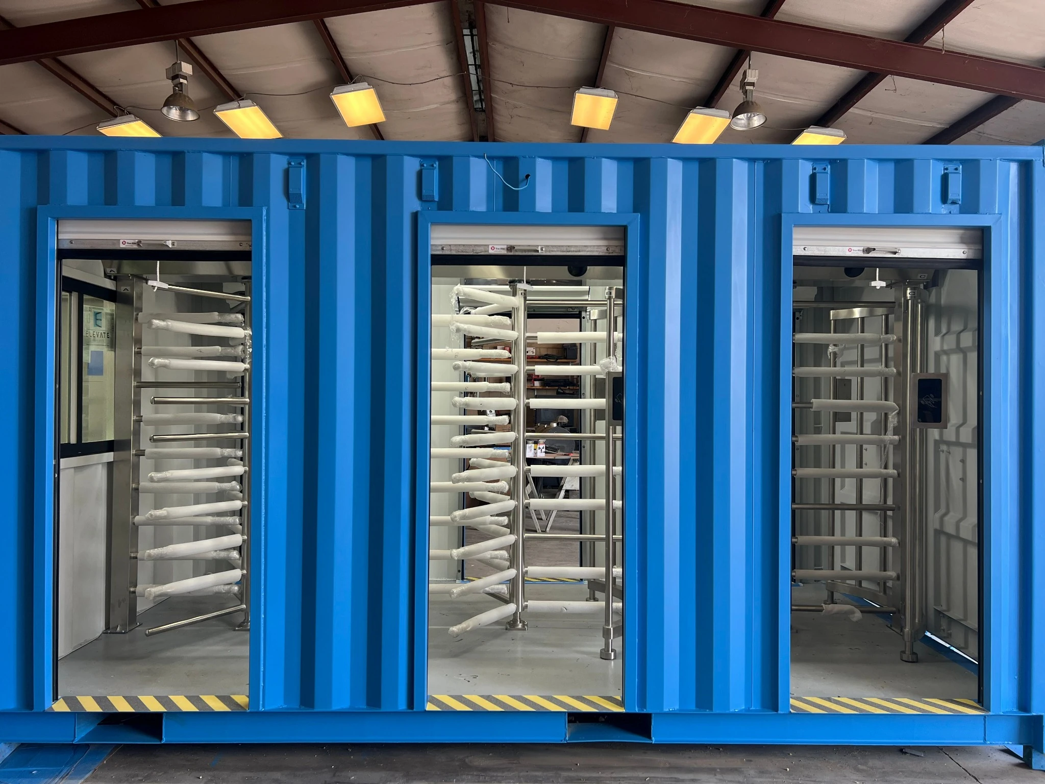 Custom container security checkpoint — three-lane front view with full-height turnstiles — 2M Technology Grand Prairie TX