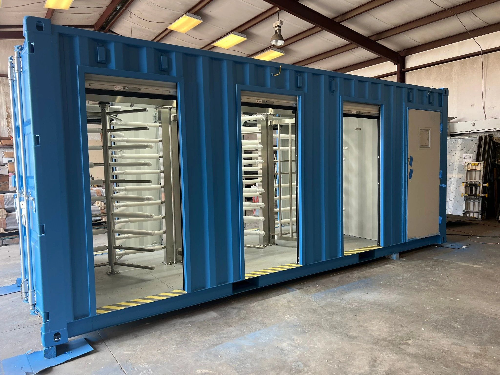 Custom container security checkpoint side view showing three turnstile lane openings — 40-ft unit Grand Prairie TX