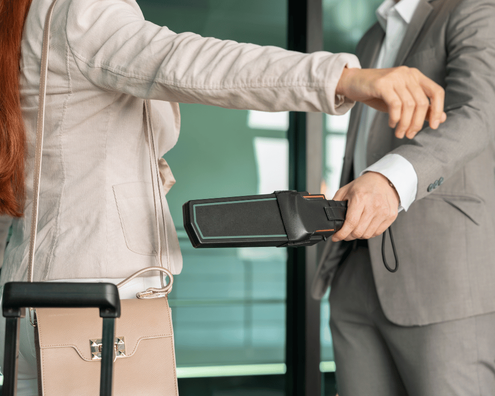 screening passenger with handheld metal detector