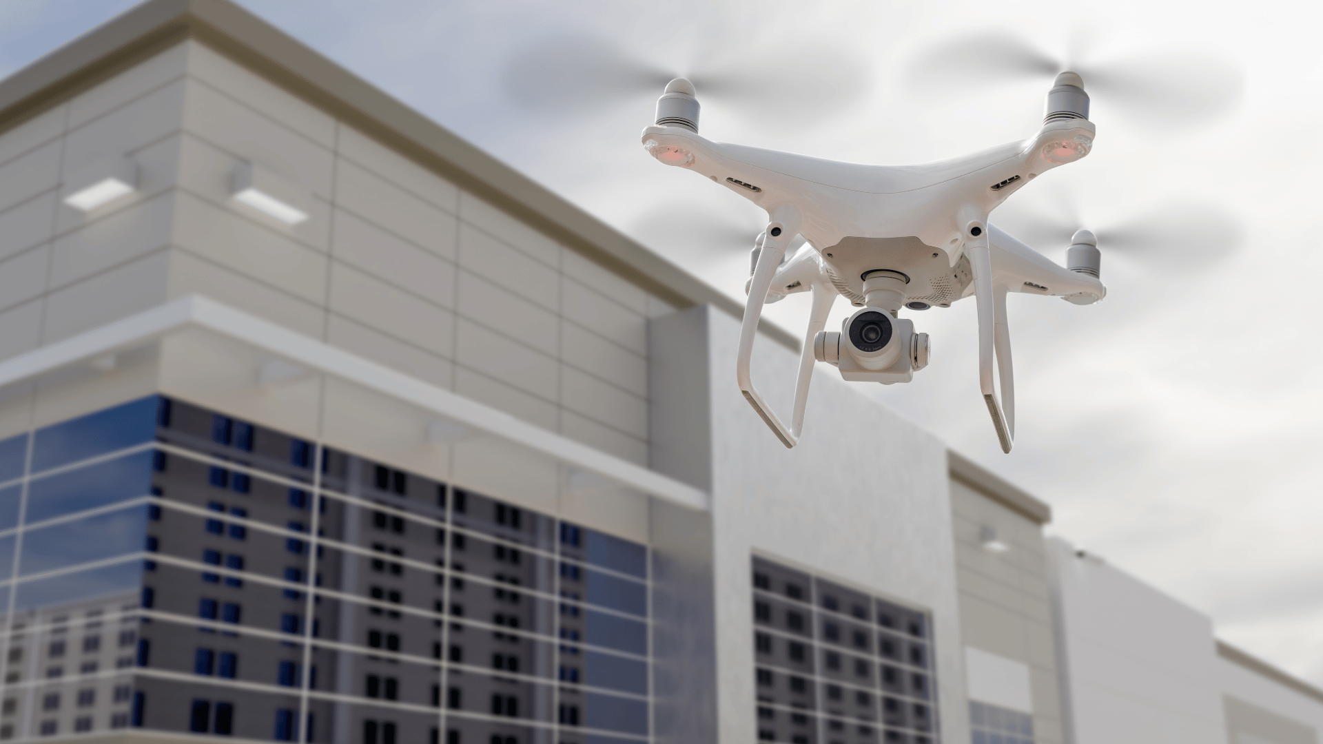 Drone flying in sky above a commercial office building