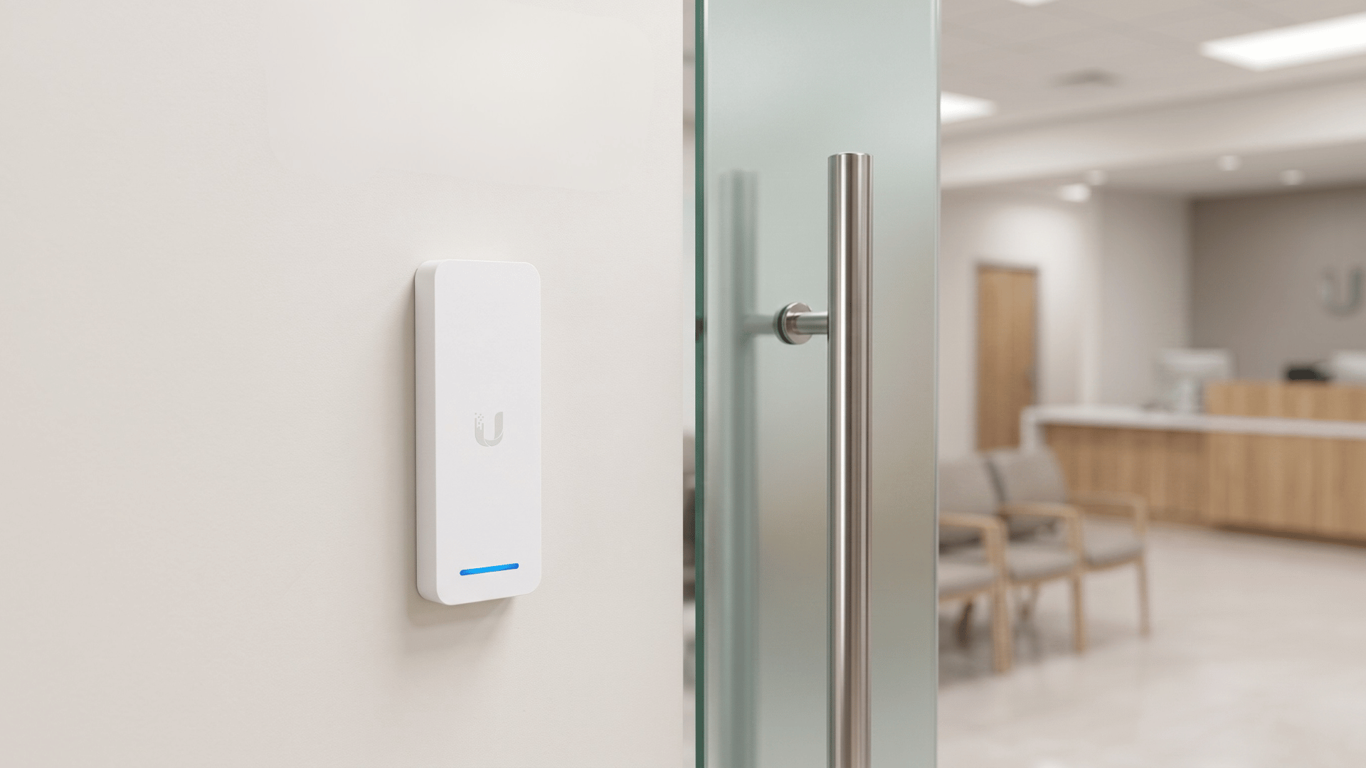 White Ubiquiti UniFi G2 Access Reader securing staff-only room inside urology medical clinic