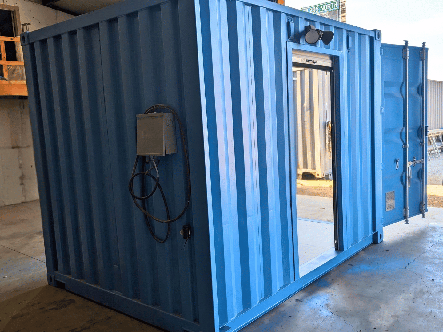Electrical junction box and wiring installed on the exterior of a custom 10-ft container turnstile checkpoint
