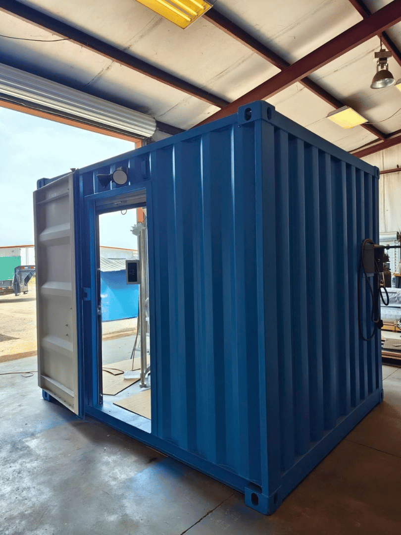 Exterior view of a completed 10-ft shipping container turnstile checkpoint with open cargo doors