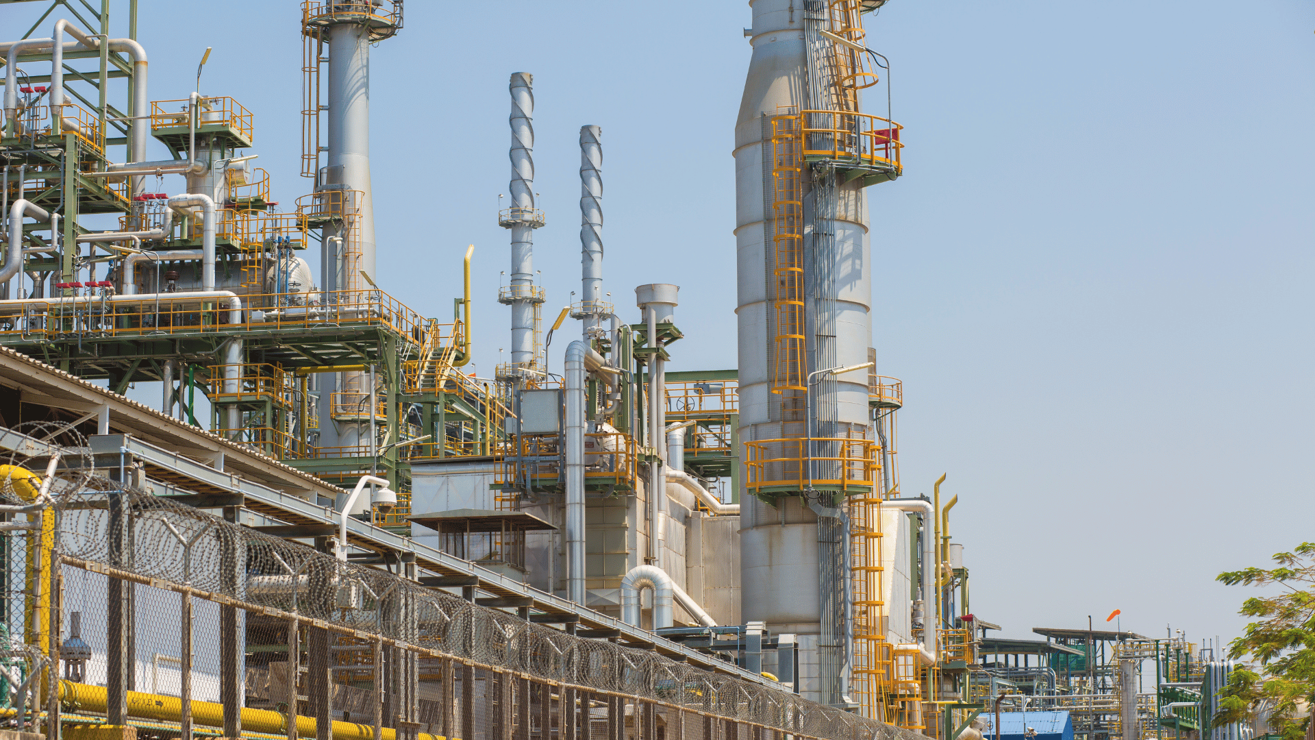 Surveillance camera monitoring perimeter outside oil refinery plant